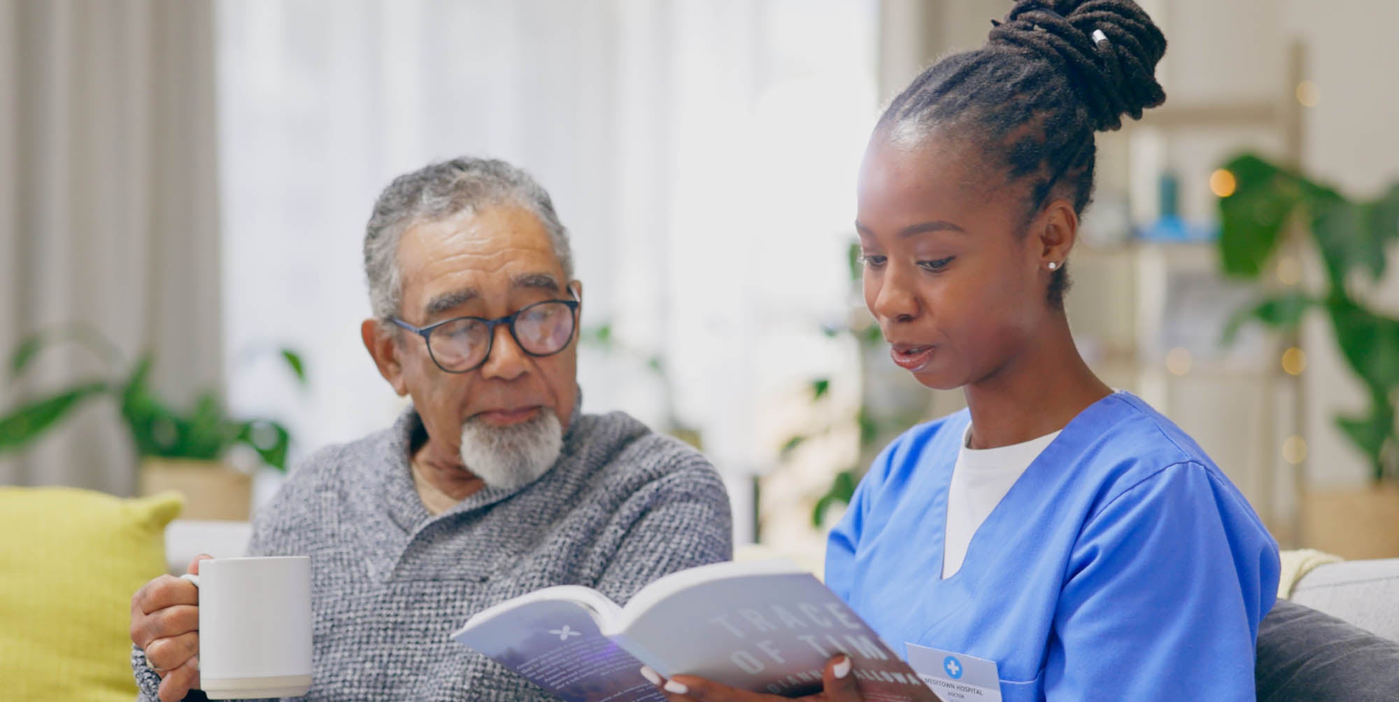 Volunteer reading to a patient